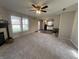 Bright living area with a ceiling fan and an open view into the kitchen at 1404 Alonzo Pl, Indianapolis, IN 46217