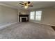 Open living room with a ceiling fan and fireplace for cozy living at 1404 Alonzo Pl, Indianapolis, IN 46217