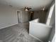 Bright, open living room showcases plush carpet, neutral walls, and ceiling fan with a light at 1404 Alonzo Pl, Indianapolis, IN 46217
