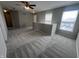 Spacious living room offers natural light with soft carpet and neutral paint all around at 1404 Alonzo Pl, Indianapolis, IN 46217