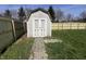 Outdoor shed with double doors and a pathway, enclosed by a freshly installed wooden fence at 1404 Alonzo Pl, Indianapolis, IN 46217