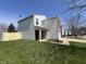 Side view of a well-maintained home with vinyl siding and a fenced yard at 1404 Alonzo Pl, Indianapolis, IN 46217