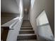 Carpeted staircase with white handrail, going upstairs with two windows bringing in plenty of light at 1404 Alonzo Pl, Indianapolis, IN 46217