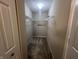 View of a carpeted walk-in closet with wire shelving and ample storage space at 1404 Alonzo Pl, Indianapolis, IN 46217