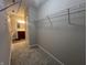 Spacious walk-in closet featuring plush carpeting, wire shelving, and additional bathroom access at 1404 Alonzo Pl, Indianapolis, IN 46217