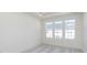 This room has neutral carpet, recessed lighting, and three windows allowing ample natural light at 14532 Hanford Ln, Carmel, IN 46074