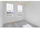 Bedroom with two windows and neutral carpet offers ample natural light at 14532 Hanford Ln, Carmel, IN 46074