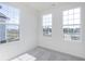 Bedroom with three large windows offering views of the neighborhood at 14532 Hanford Ln, Carmel, IN 46074