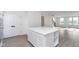 Modern kitchen with center island and open layout looking into the staircase at 14532 Hanford Ln, Carmel, IN 46074