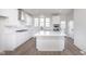 Modern kitchen with stainless steel appliances, center island, and bright white cabinets at 14532 Hanford Ln, Carmel, IN 46074