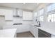 Modern kitchen with stainless steel appliances, center island, and bright white cabinets at 14532 Hanford Ln, Carmel, IN 46074