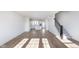 Open-concept living room with hardwood floors leading into the modern kitchen at 14532 Hanford Ln, Carmel, IN 46074