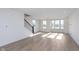 Spacious living room with hardwood floors, bright natural light, and an adjacent staircase at 14532 Hanford Ln, Carmel, IN 46074