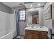 The bathroom has a shower-tub, toilet, and wood vanity with a sink and window for natural light at 1598 Thornburg Ln, Franklin, IN 46131