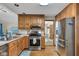 Functional kitchen with stainless steel appliances, light countertops, and abundant wooden cabinetry at 1598 Thornburg Ln, Franklin, IN 46131