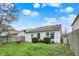 Fenced backyard with green lawn, mature bushes and small patio space; perfect for outdoor entertaining at 16838 Aulton Dr, Noblesville, IN 46060