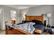 Bedroom featuring a large wood bed frame and bedside tables, leading to an ensuite bathroom at 16838 Aulton Dr, Noblesville, IN 46060