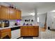 Functional kitchen featuring wood cabinets, white countertops, and an open view into the living area at 16838 Aulton Dr, Noblesville, IN 46060
