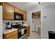 Efficient kitchen with wood cabinets, stainless steel appliances, and convenient laundry area at 16838 Aulton Dr, Noblesville, IN 46060
