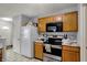 Cozy kitchen with wood cabinets, stainless steel appliances, and easy access to the door at 16838 Aulton Dr, Noblesville, IN 46060