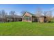 Expansive backyard featuring a sunroom, well-kept lawn, and a covered outdoor seating area for entertaining at 1791 S Conservation Club Rd, Morgantown, IN 46160