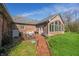 Outdoor patio featuring a brick pathway, sunroom, and a dining area, ideal for entertaining and relaxing at 1791 S Conservation Club Rd, Morgantown, IN 46160