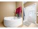 Bathroom featuring luxurious tub, neutral paint, and tile flooring at 1791 S Conservation Club Rd, Morgantown, IN 46160