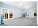Spacious primary bedroom features walk-in closet, neutral paint, carpet, and access to exterior porch through French doors at 1791 S Conservation Club Rd, Morgantown, IN 46160