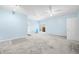 Large bedroom with neutral paint, walk-in closets, carpet, ceiling fans, and French door access to exterior at 1791 S Conservation Club Rd, Morgantown, IN 46160