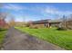 Brick house with solar panels, covered outdoor area, and a long driveway at 1791 S Conservation Club Rd, Morgantown, IN 46160