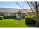 Well-maintained brick home with a manicured lawn, flowering trees and bushes under a clear blue sky at 1791 S Conservation Club Rd, Morgantown, IN 46160