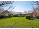 Charming brick home featuring a lush green lawn and mature landscaping under a clear blue sky at 1791 S Conservation Club Rd, Morgantown, IN 46160