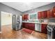 Kitchen with stainless steel appliances, hardwood floors, and natural light at 1791 S Conservation Club Rd, Morgantown, IN 46160