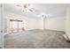Spacious living room featuring neutral carpet, ceiling fans, and ample natural light at 1791 S Conservation Club Rd, Morgantown, IN 46160