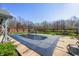 Covered outdoor pool, surrounded by a concrete patio, a verdant lawn, and a privacy fence at 1791 S Conservation Club Rd, Morgantown, IN 46160