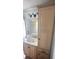 Well-lit bathroom vanity with built-in storage and white vessel sink underneath a dark fixture light at 1813 Birch Dr, Plainfield, IN 46168