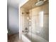 Modern tub and shower combo features glass doors, a shower head, and tile backsplash at 1813 Birch Dr, Plainfield, IN 46168