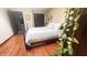This bedroom boasts wood-look floors, natural light, and a bed with a wooden frame at 1813 Birch Dr, Plainfield, IN 46168