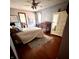 Bright bedroom with a crib, large area rug, ceiling fan, and closet providing ample storage space at 1813 Birch Dr, Plainfield, IN 46168