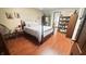 Light and airy bedroom with wood-look floors, lots of light, and charming decor at 1813 Birch Dr, Plainfield, IN 46168
