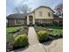Charming exterior with brick walkway and lovely landscaping in the front yard at 1813 Birch Dr, Plainfield, IN 46168