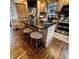Kitchen island with black countertops and three stools, perfect for casual dining at 1813 Birch Dr, Plainfield, IN 46168