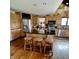 Modern kitchen boasts stainless steel appliances, granite countertops, a breakfast bar, and hardwood floors at 1813 Birch Dr, Plainfield, IN 46168