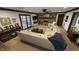 Open living room featuring a stone fireplace, ceiling fan, and ample seating at 1813 Birch Dr, Plainfield, IN 46168