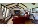 Sunlit living room with wood beams, comfortable seating, and an entertainment center at 1813 Birch Dr, Plainfield, IN 46168