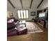 Cozy living room with wood beams, leather furniture, and a stylish area rug at 1813 Birch Dr, Plainfield, IN 46168