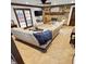 Bright living room features a stone fireplace, large sectional sofa, and French doors at 1813 Birch Dr, Plainfield, IN 46168