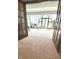Bright living room with french doors, large arched window, and neutral carpet at 1813 Birch Dr, Plainfield, IN 46168