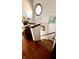 Carpeted staircase with wooden banister and a round window, adorned with plants and stylish decor at 1813 Birch Dr, Plainfield, IN 46168