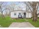 Backyard view featuring grass, a sidewalk, and partial fencing at 1946 N Riley Ave, Indianapolis, IN 46218